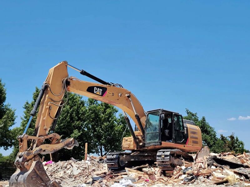 Division 31 excavator performing structural demolition